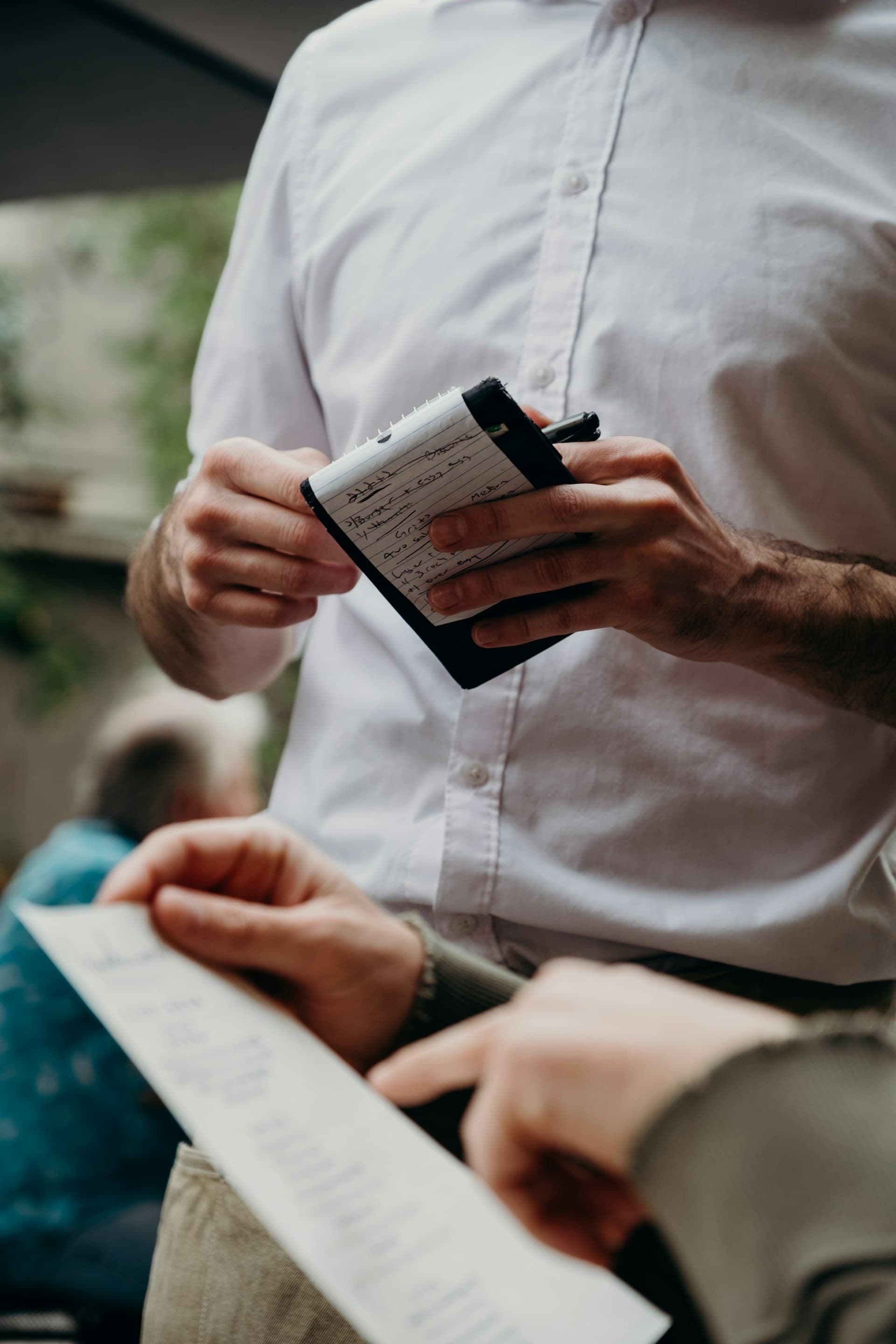 A restaurant operator reviewing handwritten notes