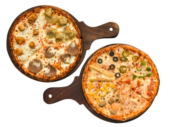 Two pizzas plated on wooden boards, ready to be menu-engineered