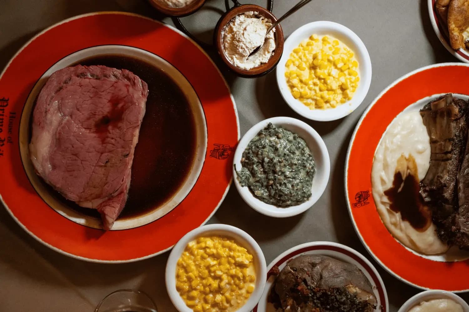 Prime rib carved tableside with corn, creamed spinach, and Yorkshire pudding at House of Prime Rib