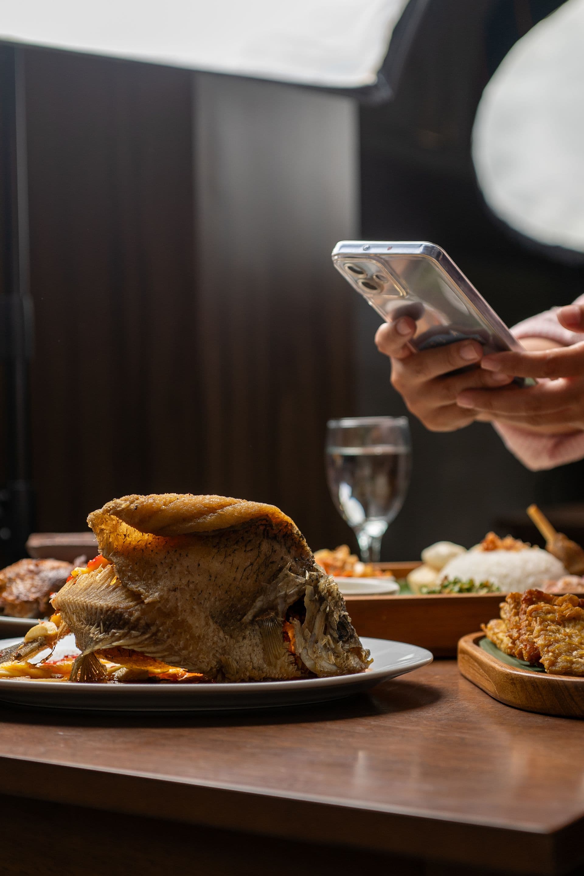 A guest photographing their meal to leave a review
